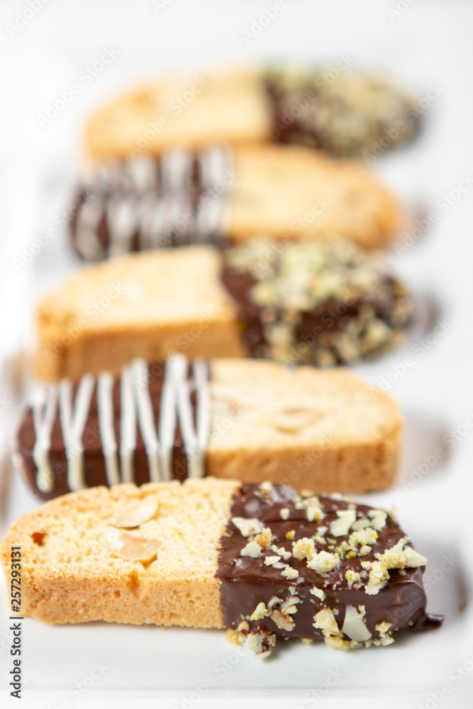 Cantuccini biscuits with chocolate and pistachios. Italian biscotti on white plate Cantuccini biscuits with chocolate and pistachios. Italian biscotti on white plate