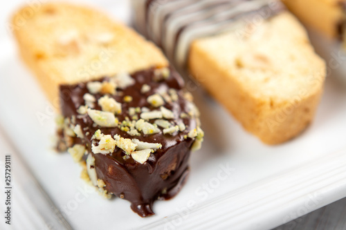 Cantuccini biscuits with chocolate and pistachios. Italian biscotti on white plate