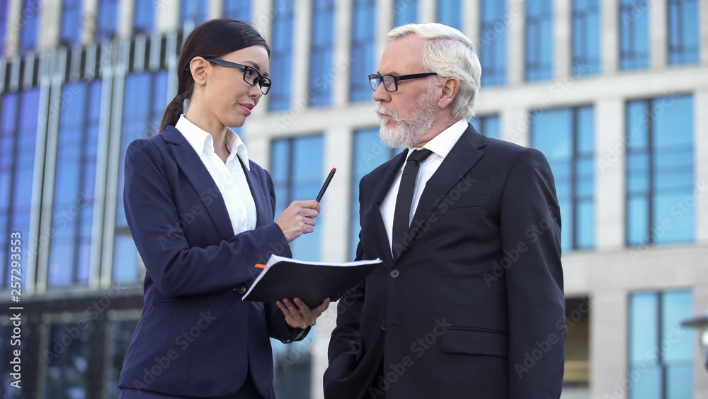 Female director giving pen to elderly investor, signing contract, cooperation Female director giving pen to elderly investor, signing contract, cooperation