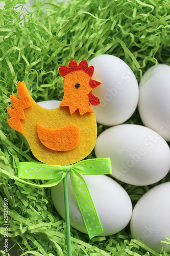 White eggs on green background. Easter. Easter background. Spring, Easter holiday. Eggs and Easter decoration decoration, chicken toy. Copy space.