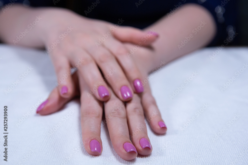 Fototapeta premium Hands with beautiful nails painted bright, manicure