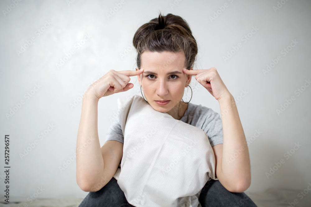 Portrait of beautiful woman has headaches. White background Portrait of beautiful woman has headaches. White background