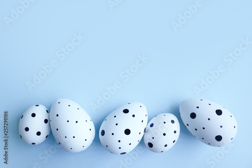 Ester eggs in isolated on blue background. Copy space
