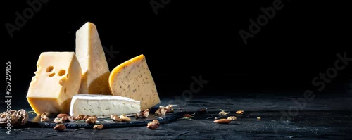 Panel kuchenny z motywem Different kinds of cheese with nuts on dark background, copy space
