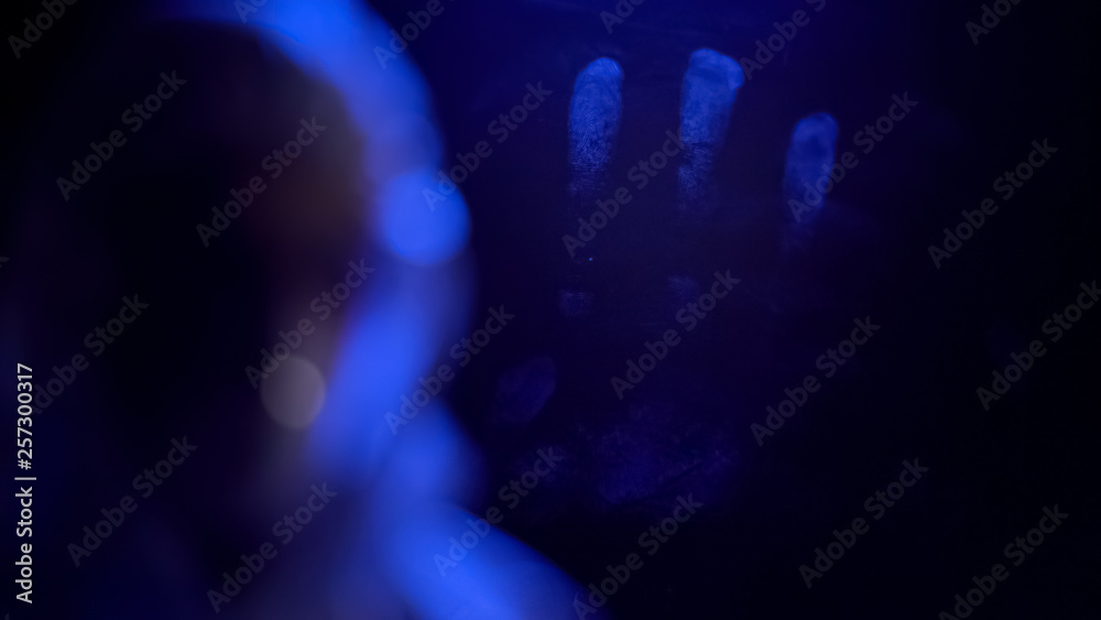 Hand fingerprint on window glass, crime evidence, forensic science research Hand fingerprint on window glass, crime evidence, forensic science research