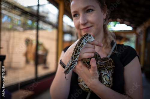 Caucasian girl holds snake in Langkawi Wildlife Park
