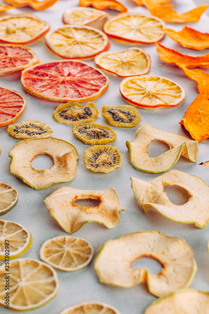 Mixed dried fruits and vegetables slices on white background
