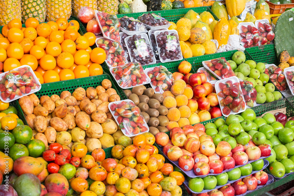 pile of fruits on the shelf of a Colombian market