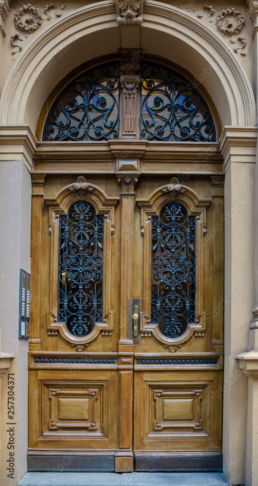 Wooden door with ornaments of wrought iron