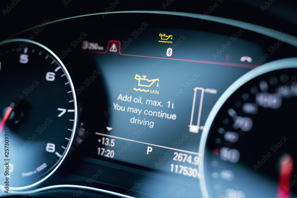 Luxury car color screen dashboard with warning message. Low engine oil level indication. Intelligent Driver Information System Luxury car color screen dashboard with warning message. Low engine oil level indication. Intelligent Driver Information System