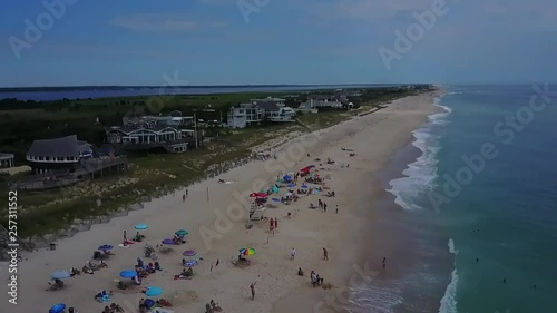 AERIAL & SLOW MOTION: panning and pushing over the shoreline of East Quogue, New York on a bright and sunny day. photo