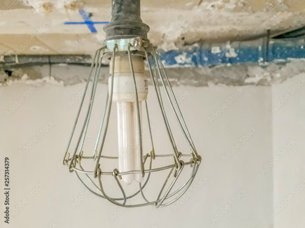 Bulb in a work with metal protection that surrounds it and the bottom of the construction