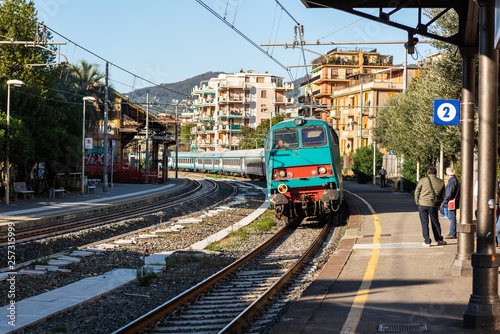 Electric regional train is arriving to walkway platform of Rapallo town, Italy