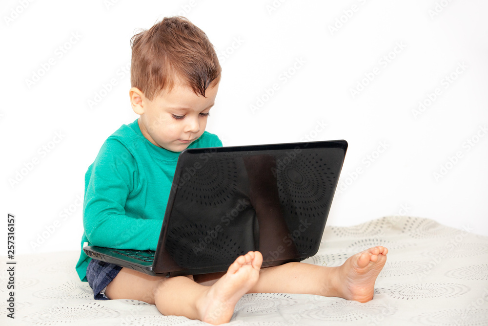 emotional boy with laptop on a light background emotional boy with laptop on a light background