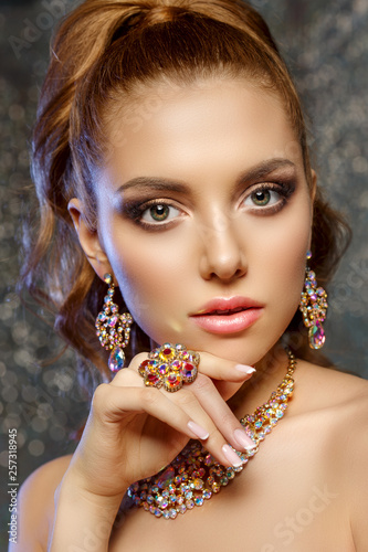 Brilliant. Girl with luxury jewelry. Model with a precious stone. Woman with a diamond.