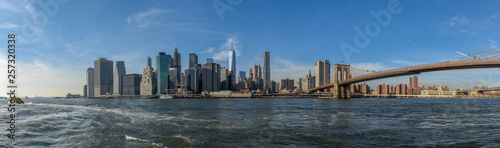 Manhattan skyline on a sunny day with Brooklyn Bridge in view © manophoto