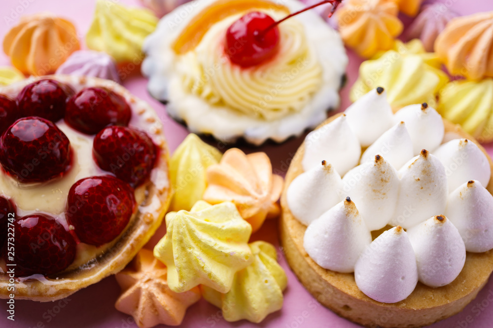 dessert background. delicious assorted cakes. cream cheese cupcake, berry tart, lemon meringue tart. sweet treats and cookies, confectionery dessert background. delicious assorted cakes. cream cheese cupcake, berry tart, lemon meringue tart. sweet treats and cookies, confectionery