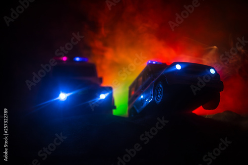 Police car chasing a car at night with fog background. 911 Emergency response police car speeding to scene of crime. Selective focus