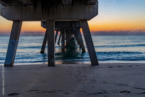 under the pier at sunrise