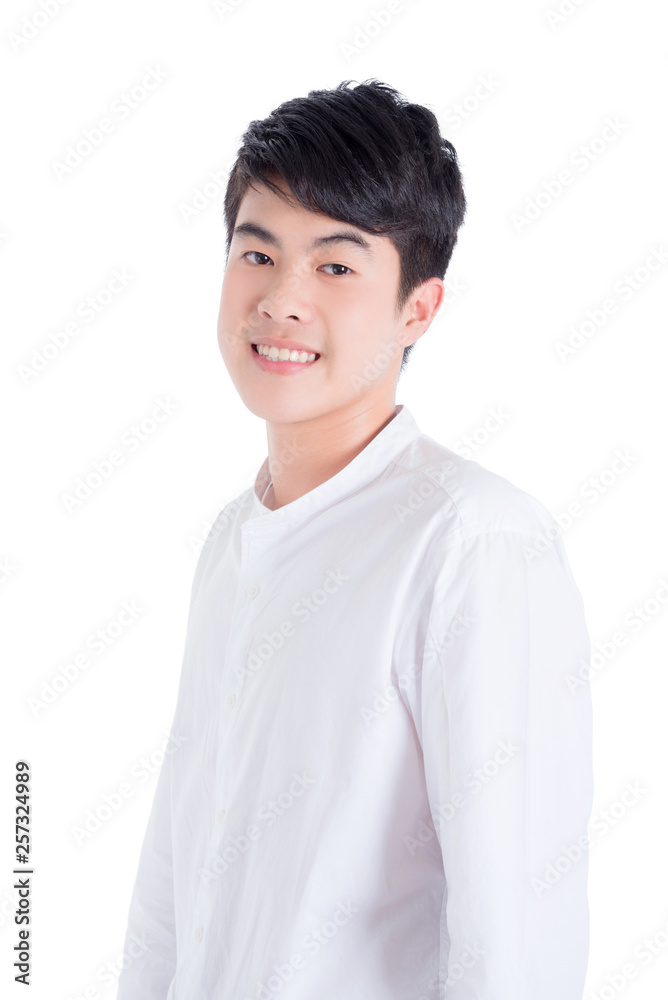 Young handsome man wearing white shirt standing and smiles over white background Young handsome man wearing white shirt standing and smiles over white background