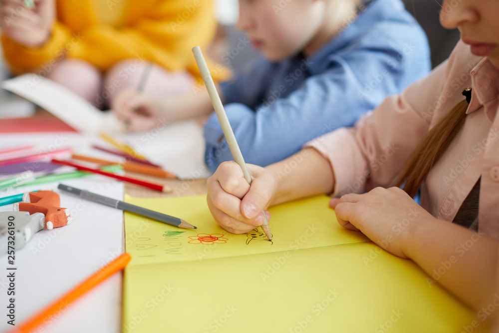 Closeup of unrecognizable little girl making handmade greeting card for holiday, copy space Closeup of unrecognizable little girl making handmade greeting card for holiday, copy space