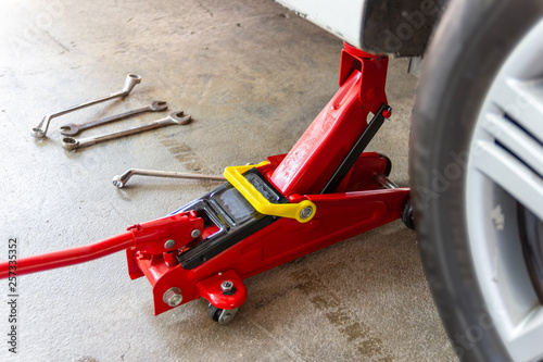red tool jack lift car for repair check Maintenance of cars  © piyaphunjun