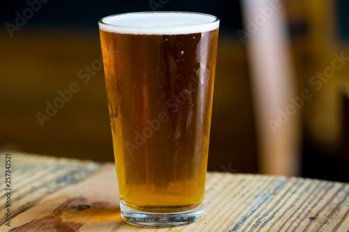 glass of beer on wooden table