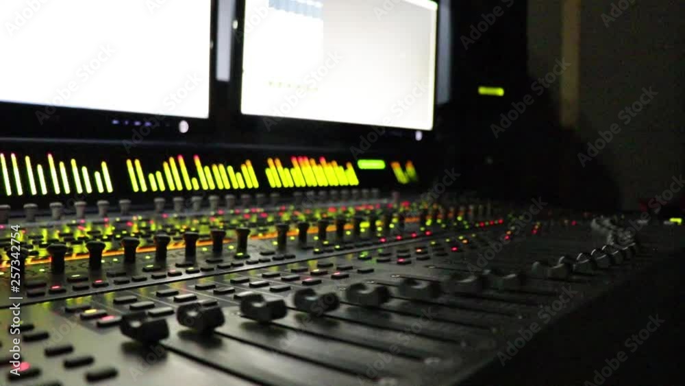 movement of the commands of an audio mixer in a recording studio without light