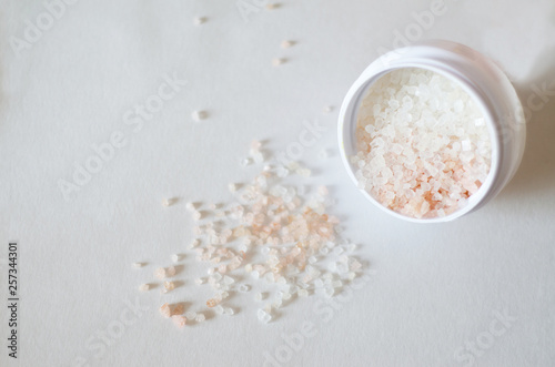 bath salt crystals in a white jar on a light background