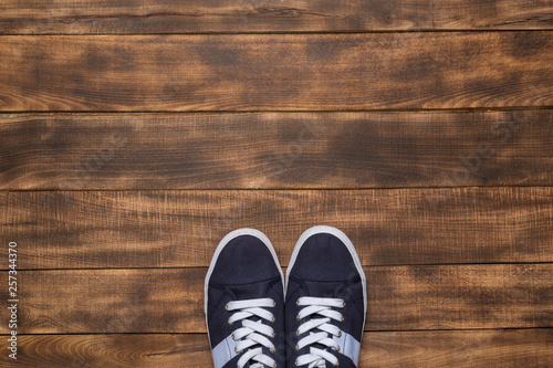 Sneakers on wooden background. Fashion blog or magazine concept.