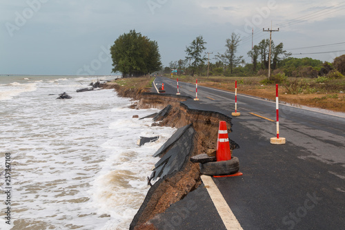 Waves of sea erode the road.