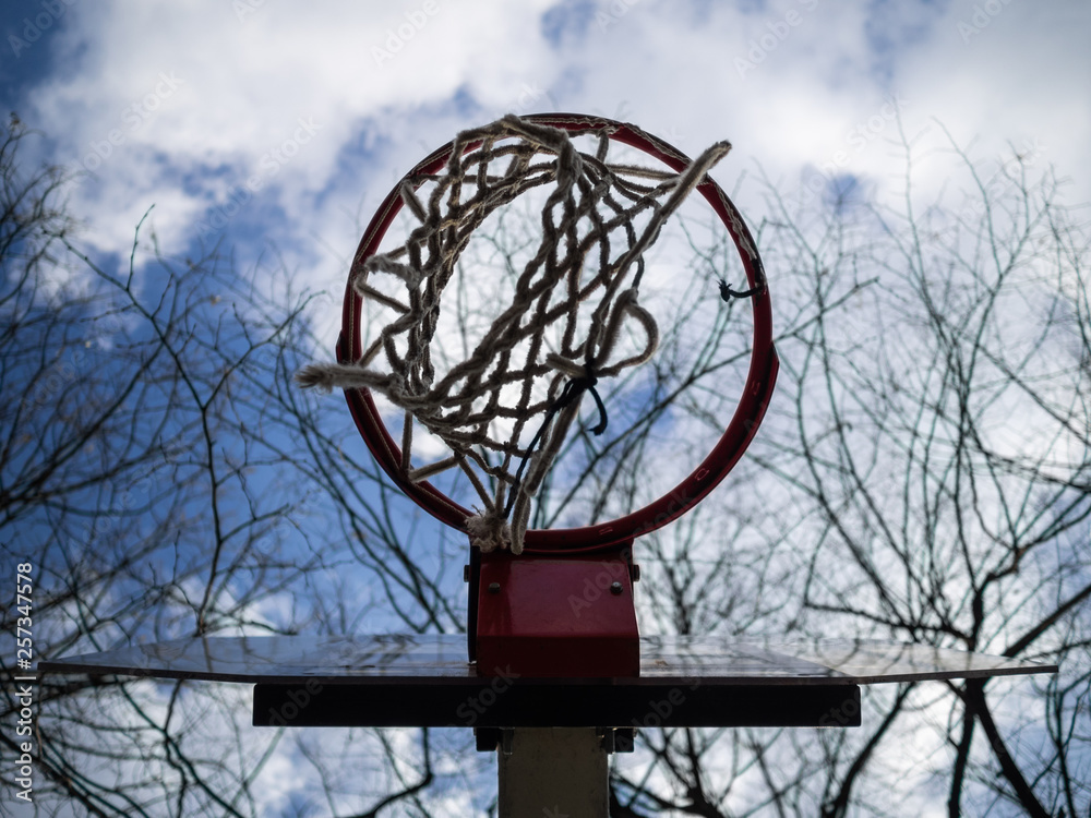 Basketball ring against the background of the blue sky with clouds. Sports ground Basketball ring against the background of the blue sky with clouds. Sports ground