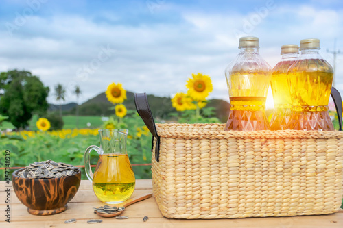 Fototapeta Naklejka Na Ścianę i Meble -  Organic sunflower oil in the glass jar with sunflower seeds, Outdoors.