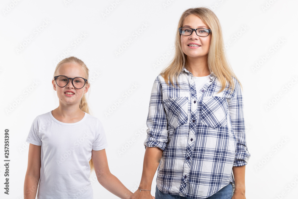 Portrait of mother and daughter with eyeglasses on white background Portrait of mother and daughter with eyeglasses on white background