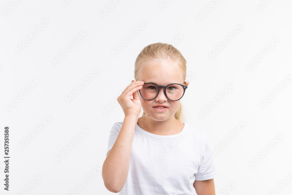 Beautiful child girl with glasses isolated on white