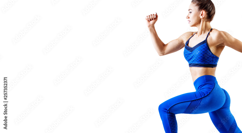 Fototapeta premium Young woman runner in blue sportswear jump in the air.