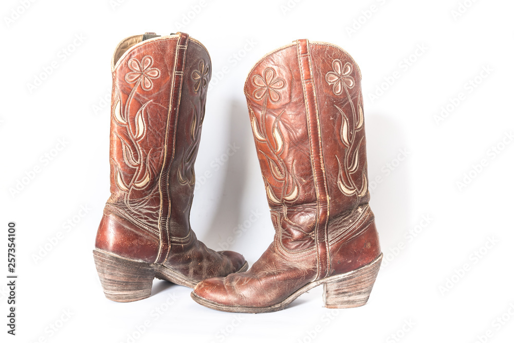 Old dirty cowboy boots on a white background Old dirty cowboy boots on a white background