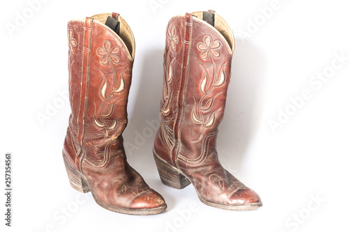 Old dirty cowboy boots on a white background