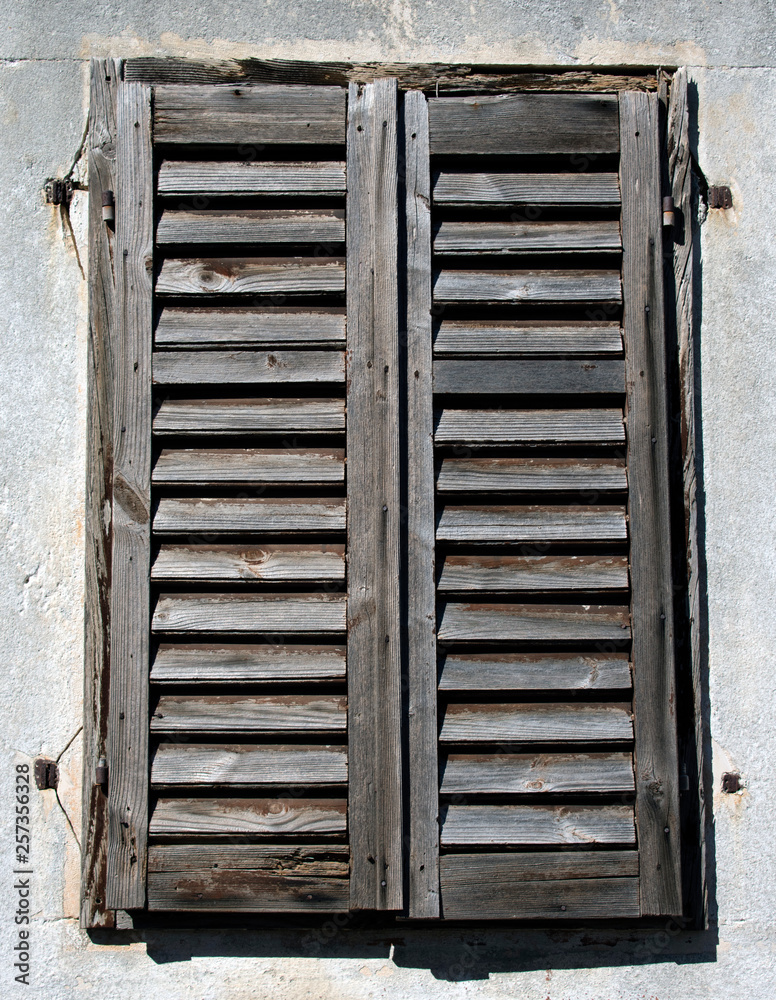 Old rustic wooden blinds on a window frame Old rustic wooden blinds on a window frame