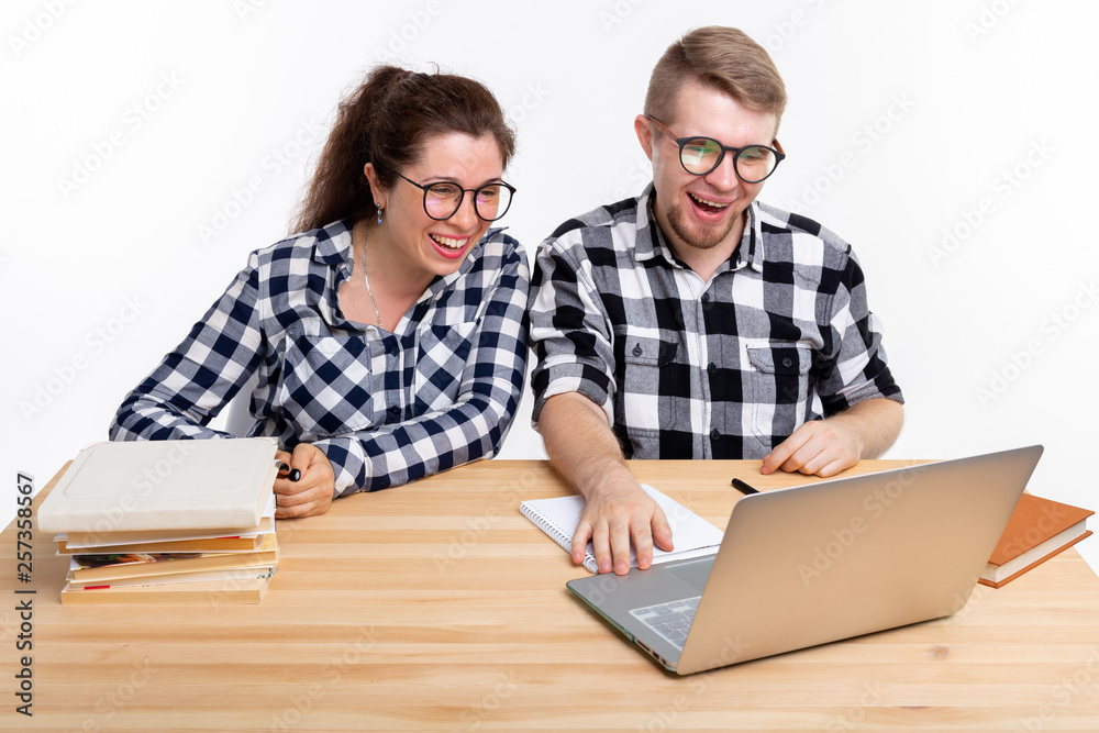 People and education concept - Two students dressed in plaid shirt sitting at a table