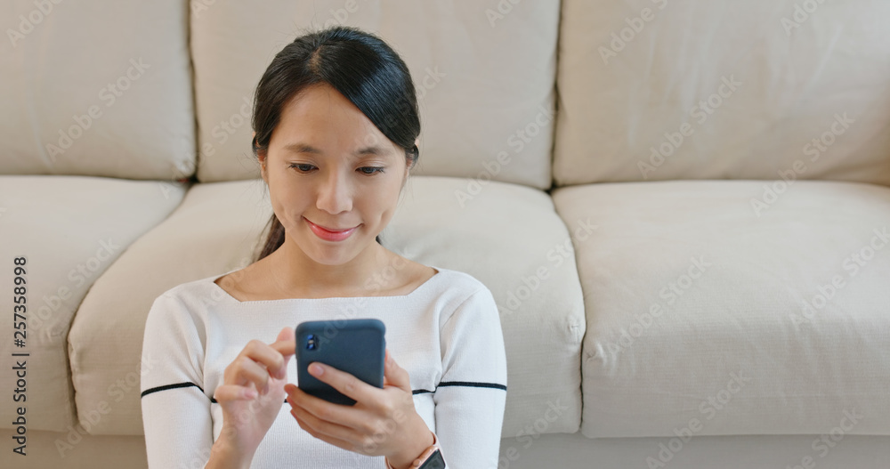 Woman look at mobile phone at home Woman look at mobile phone at home