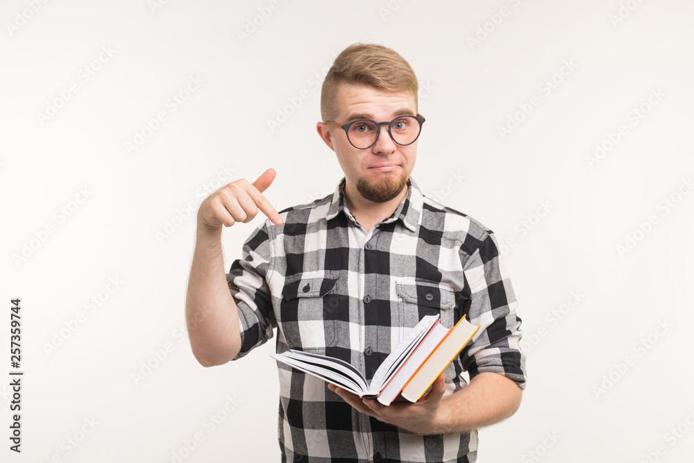 People, knowledge and education concept - Smart man point on books in his hands over white background. People, knowledge and education concept - Smart man point on books in his hands over white background.