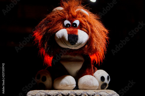 Plush lion toy with backlight. Children toy in dark place