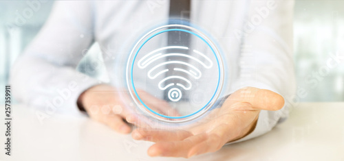 Businessman holding Wifi icon with stats and binary code 3d rendering