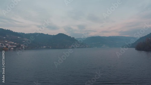 Aerial 4k shot near the water of the Douro river under a blue dusk, in Baião, Portugal. photo