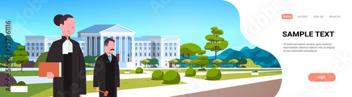 judge man woman couple court workers in judicial robe holding book and hummer standing in front of courthouse exterior landscape background horizontal portrait