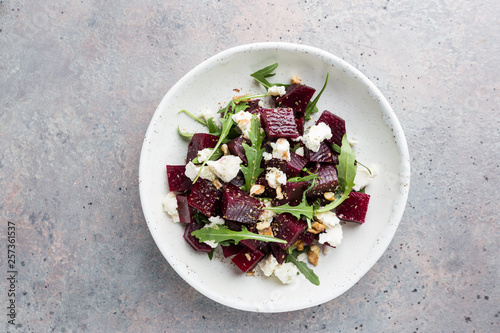 Canvas Print beetroot salad with blue cheese, arugula and walnut in a white plate on gray bac