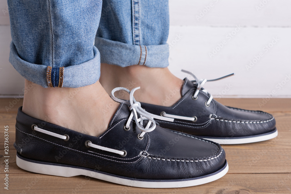 men's legs in blue shoes, comfortable summer moccasins