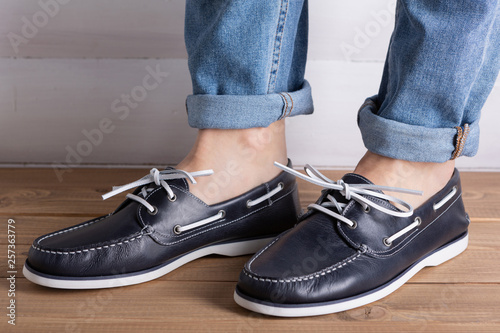 men s legs in elegant blue moccasins  comfortable summer shoes  the concept of summer and shopping