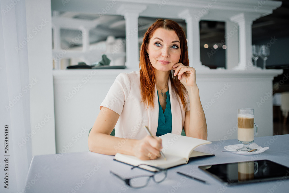 businesswoman on a coffee break. Using tablet computer.